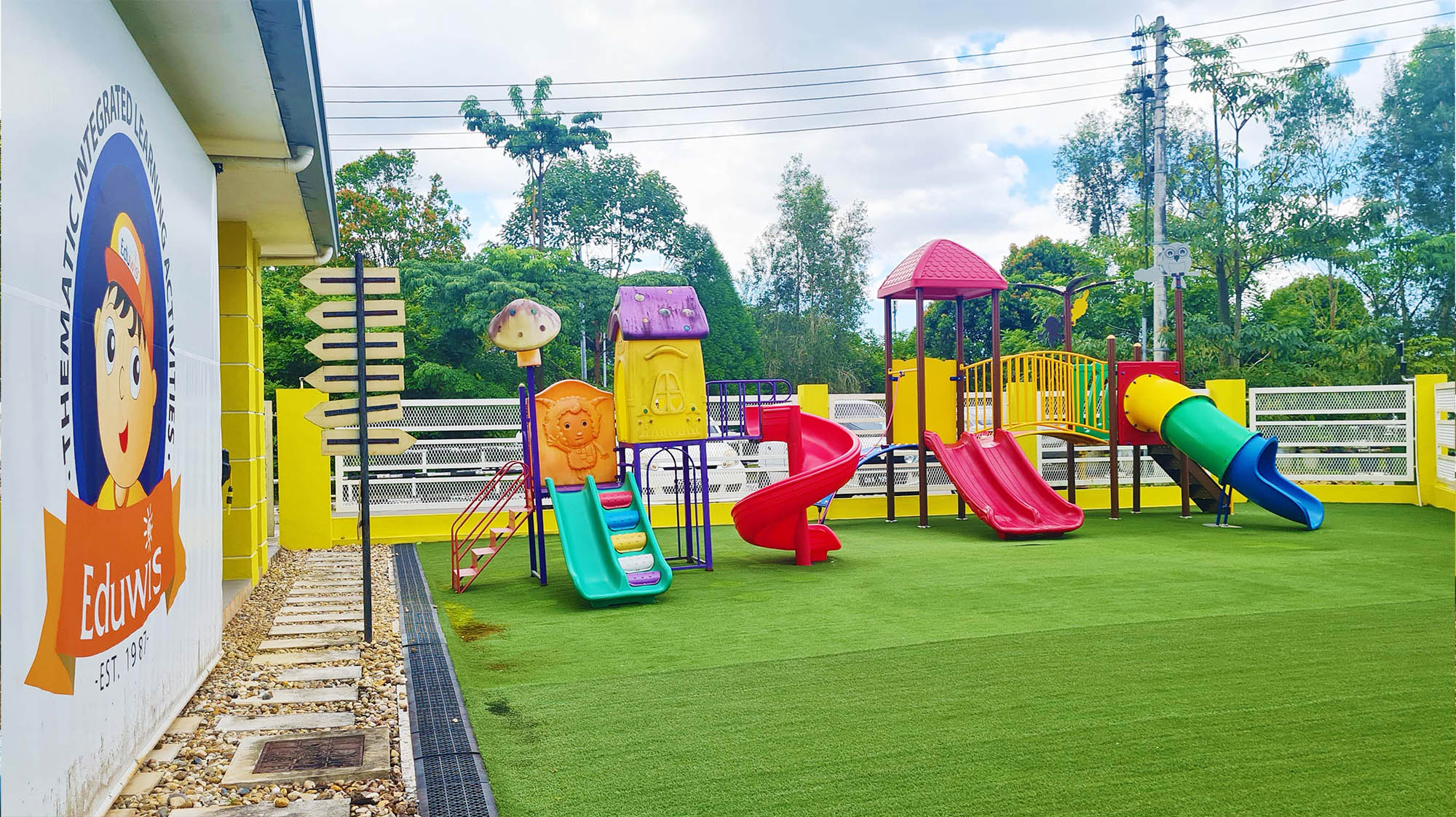 Playground area at Eduwis Kindergarten in Kuching featuring colorful slides and fun outdoor play equipment with a safe and engaging environment for children.
