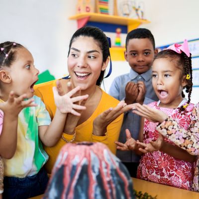 kids playing along with teacher at best preschool in KL